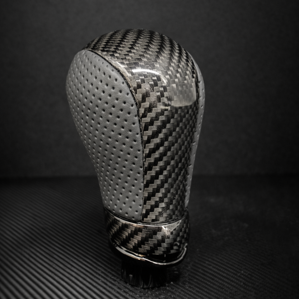 Carbon fiber gear shift knob on a dark background